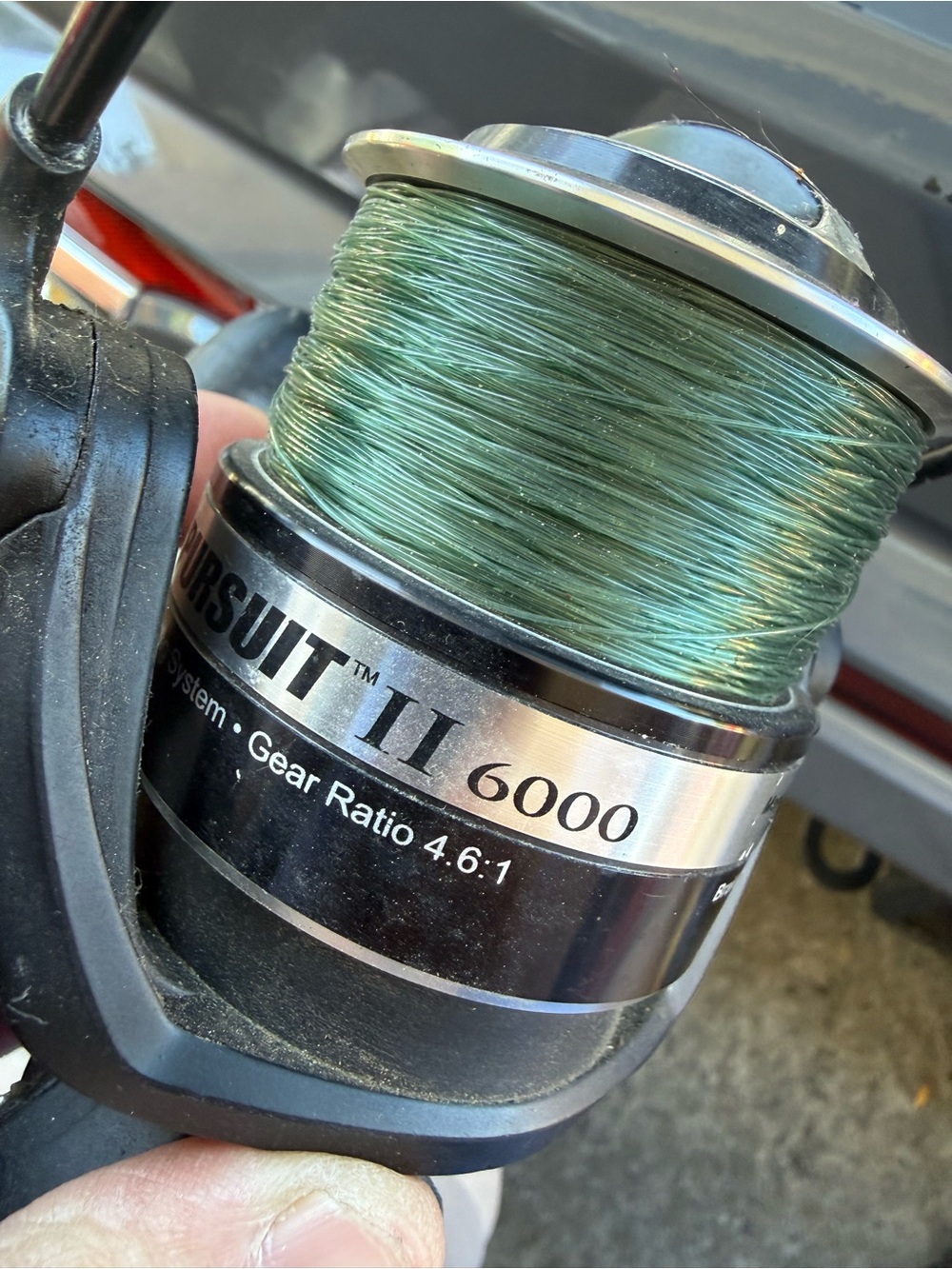Penn Pursuit II 6000 spinning reel a black body silver anodized aluminum spool.